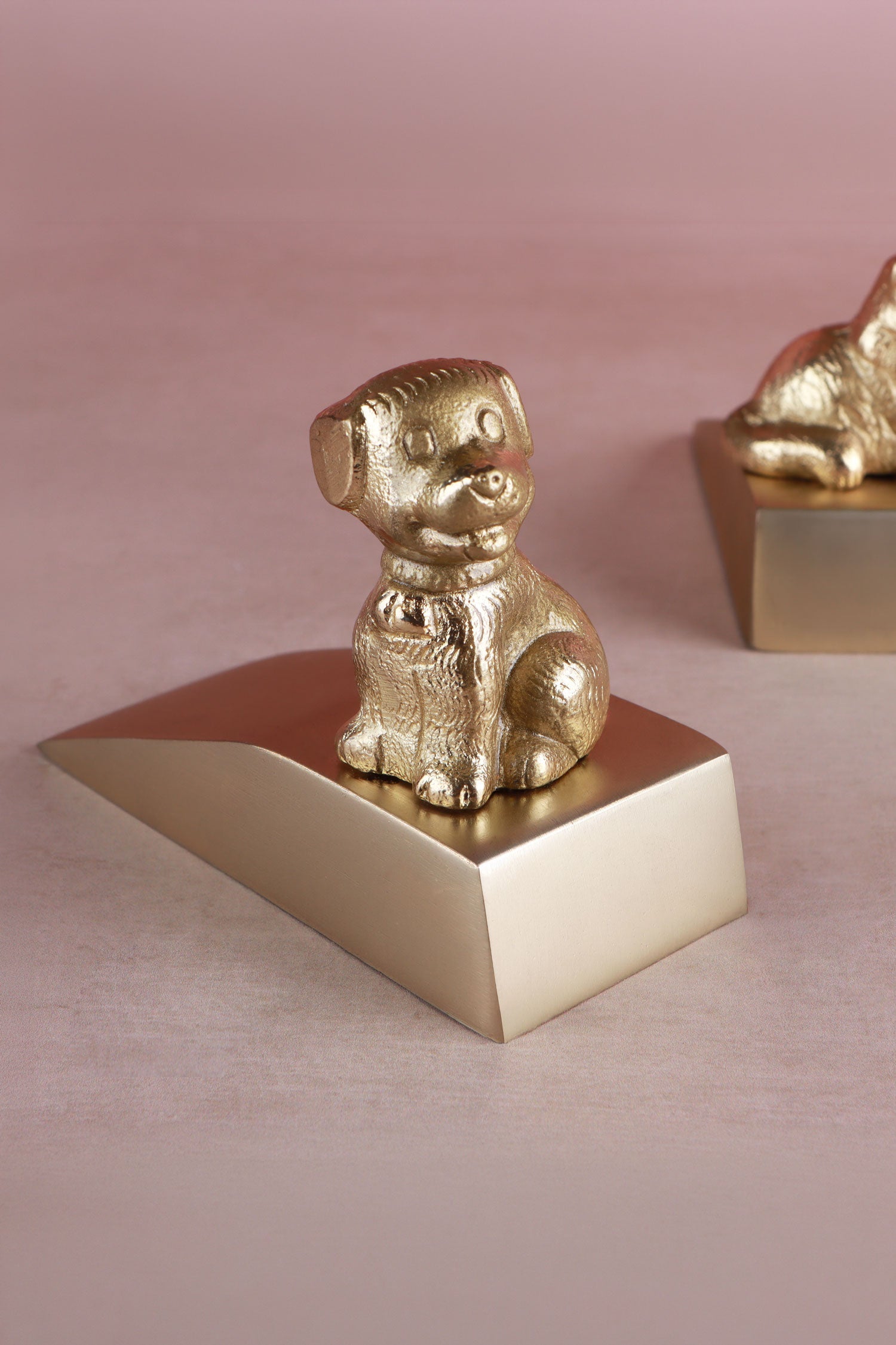 Dog door stopper in polished brass, close detail of the cast figure