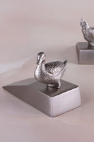 Duck door stopper in chrome on a weighted wedge base