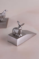 Rabbit door stopper in chrome on a weighted wedge base