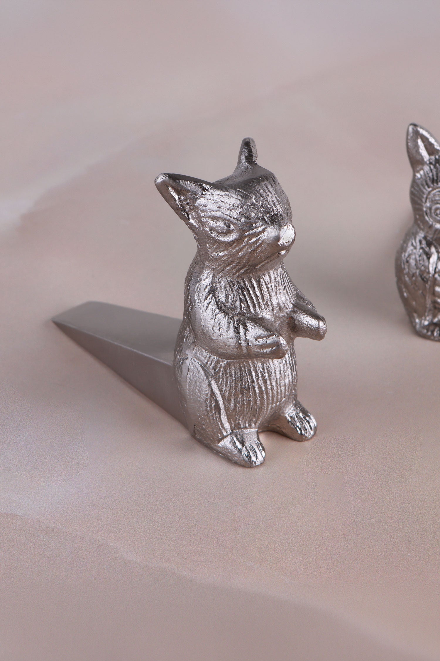 Squirrel door stopper in chrome