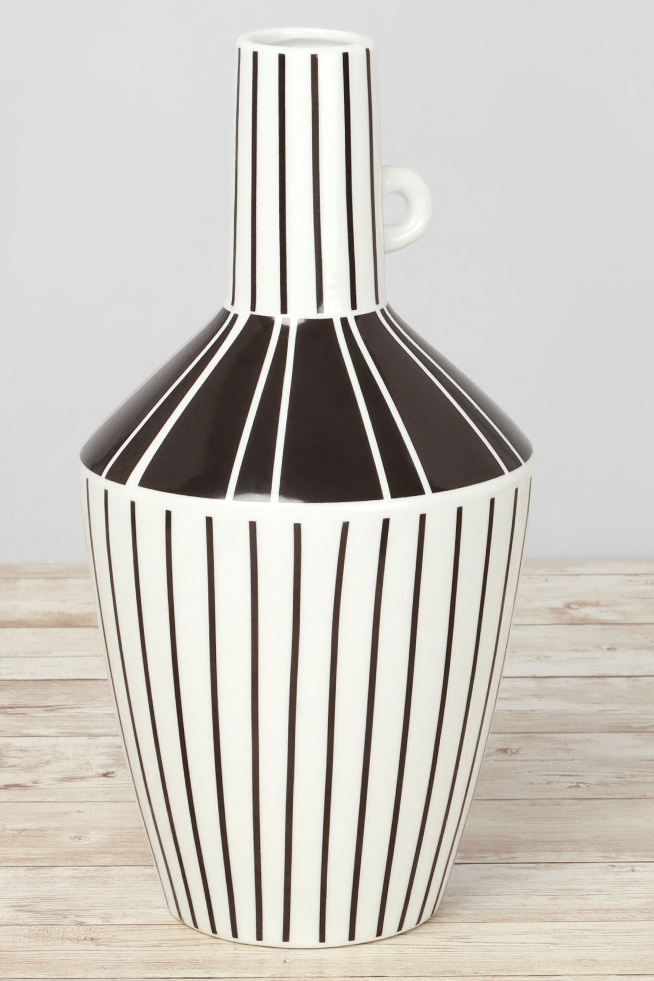 Black and white ceramic vase with vertical stripes on a wooden surface, G Decor home décor