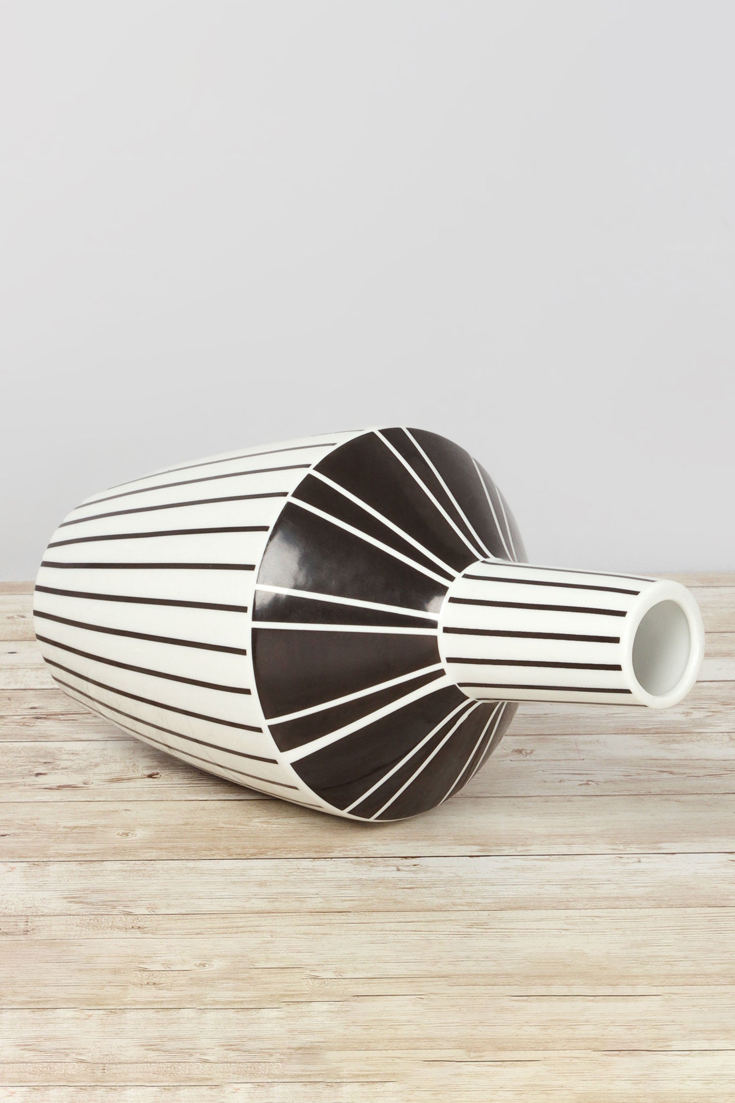 Modern black and white striped ceramic vase from G Decor on wooden table