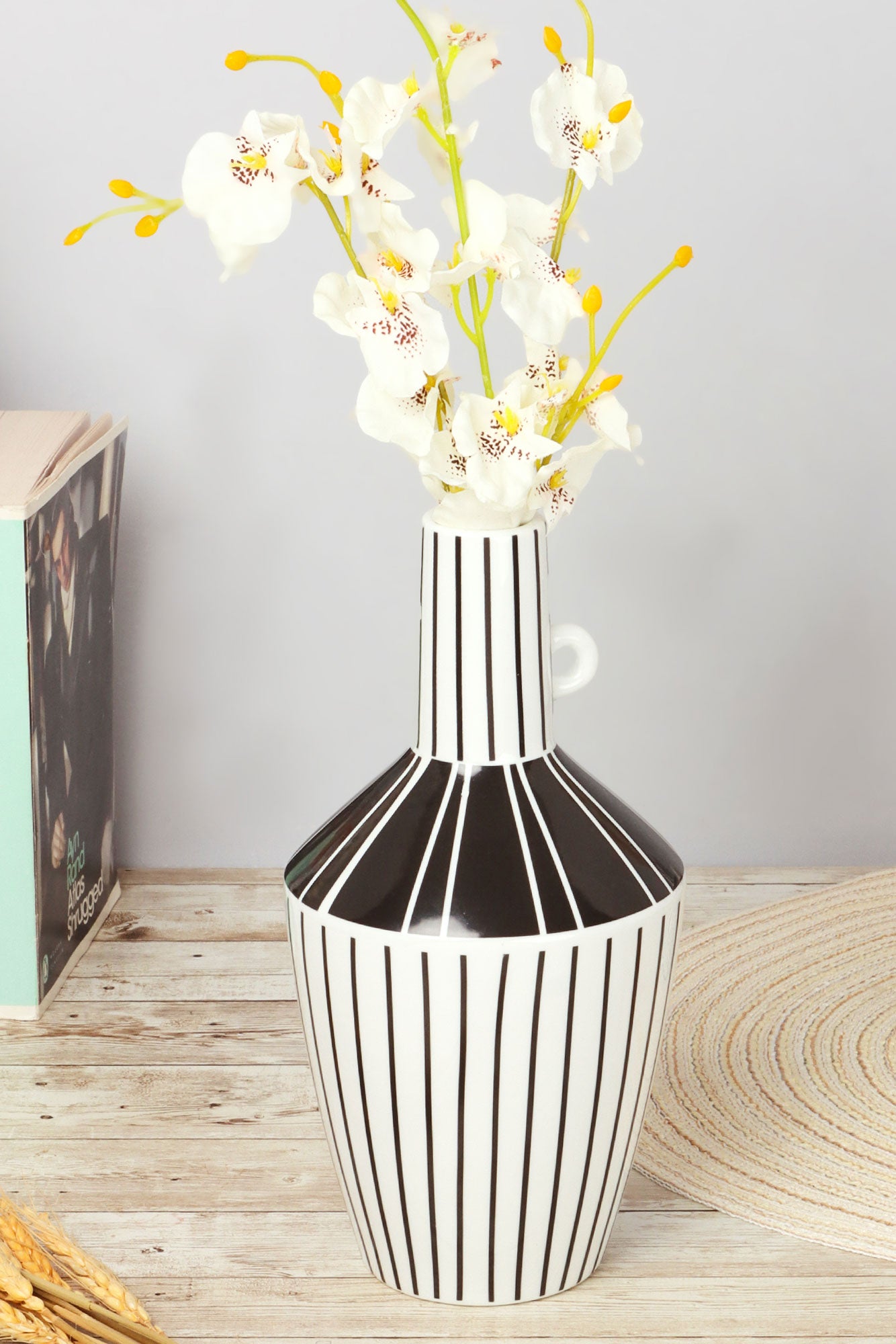 Modern black and white striped vase with white orchids on wooden table, G Decor home décor