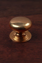Bun aged brass cabinet knob, domed on a stepped rose, 38mm