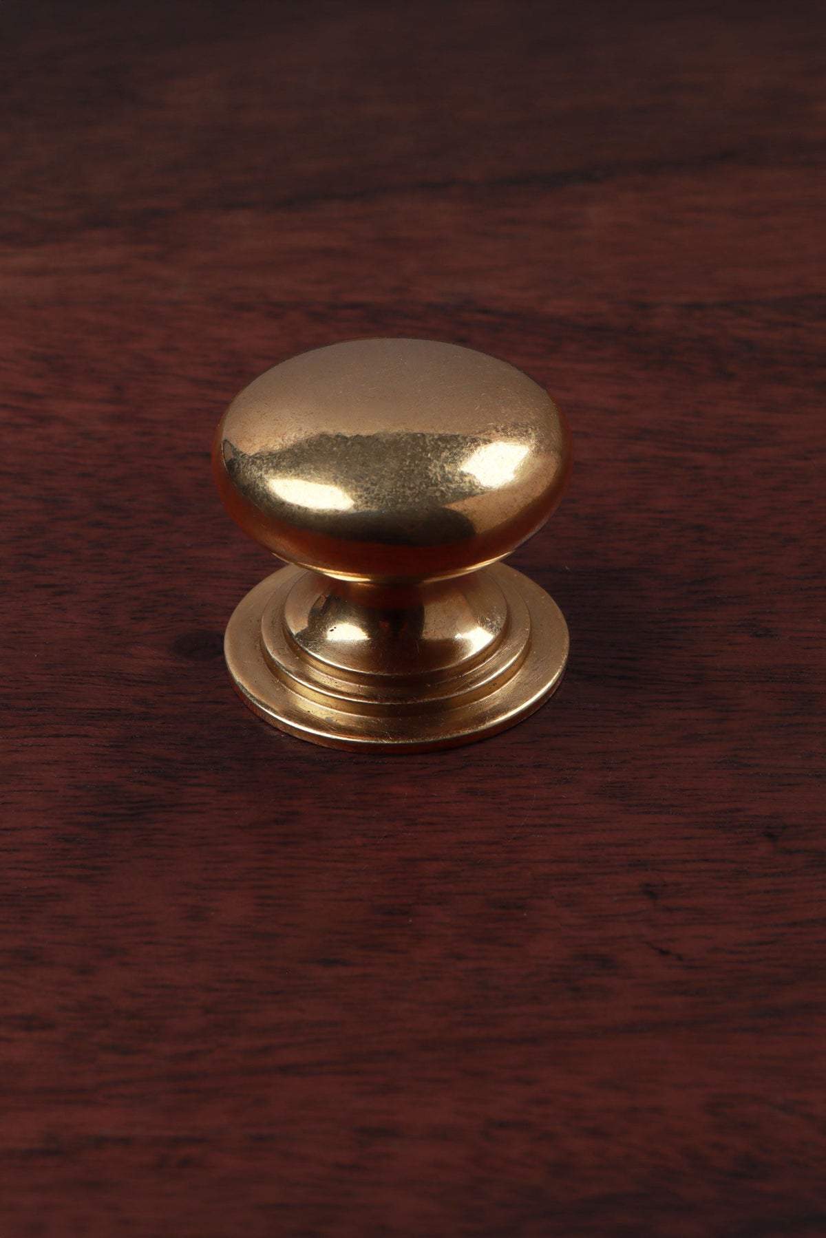 Bun aged brass cabinet knob, domed on a stepped rose, 32mm