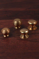 Aged brass cabinet knobs shown together