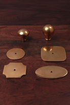Aged brass cabinet knobs shown with matching brass backplates