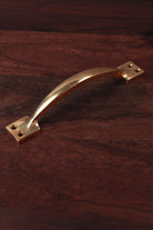 Aged brass cupboard pull handle, 6 and a quarter inch, bowed with square backplates