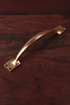 Aged brass cupboard pull handle, 8 and a quarter inch, bowed with square backplates