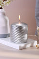 Silver metallic pillar candle with spiral texture on a white tray, luxury home décor by G Decor