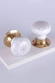 G Decor luxury brass and white ceramic flower pattern door knobs on a white surface