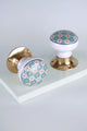 Pair of G Decor luxury ceramic and brass door knobs with blue geometric pattern on white background