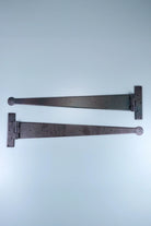24″ Pair of Hand-Forged Coinbase T Hinges in Beeswax Finish — G Decor
