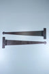 Two black metal strap hinges for doors or cabinets on a light blue background, G Decor hardware