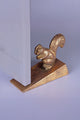 Gold squirrel door stopper luxury hardware by G Decor on a light surface