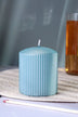 Blue ribbed pillar candle from G Decor on a woven placemat, luxury home décor accent