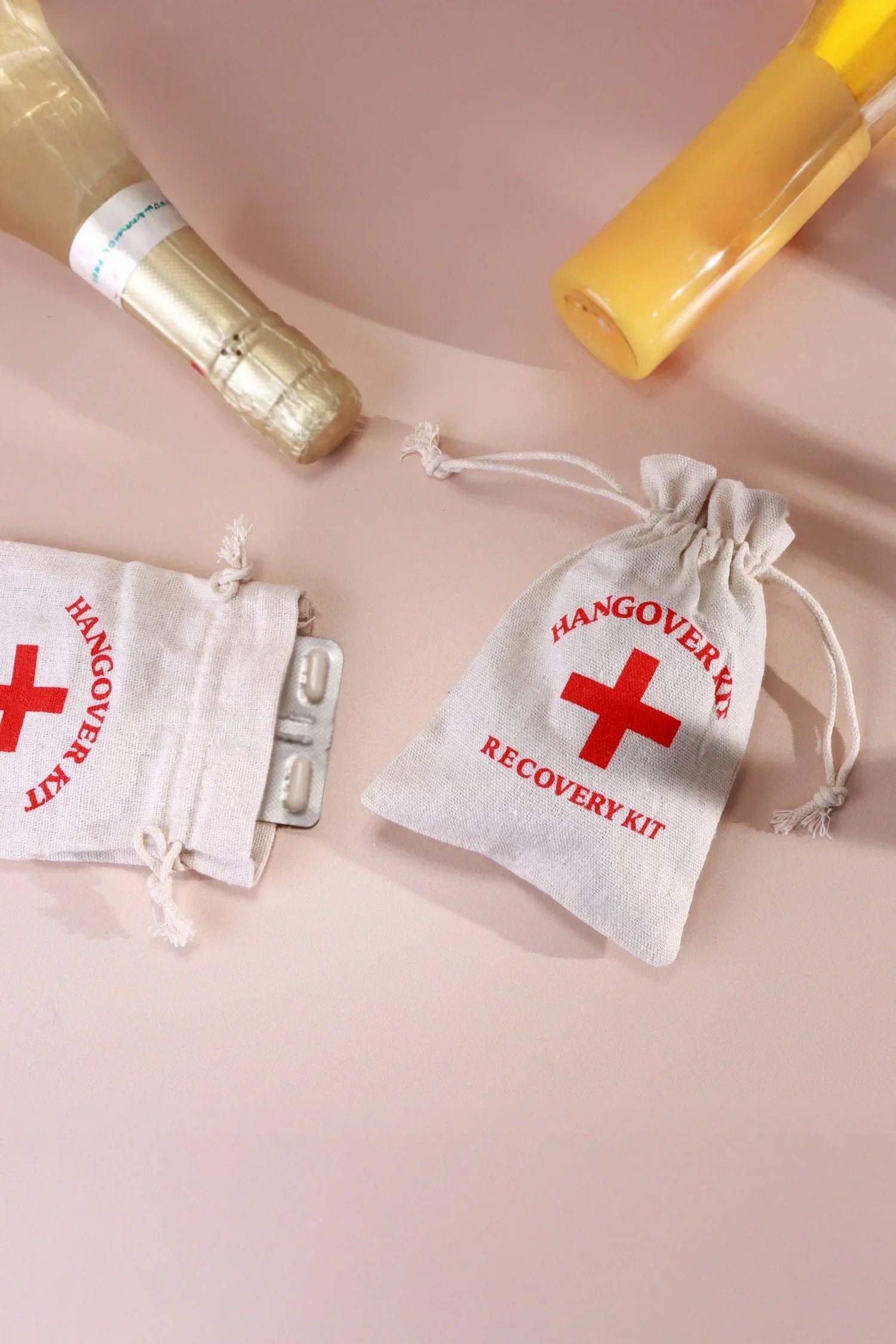 Pair of Hangover Kit Linen Gift Bags with Red Cross Design — lifestyle view, G Decor