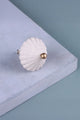 Luxury white scalloped cabinet knob with gold accent by G Decor on blue surface