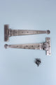 Pair of metal T-hinges with screws on light blue background, G Decor luxury hardware