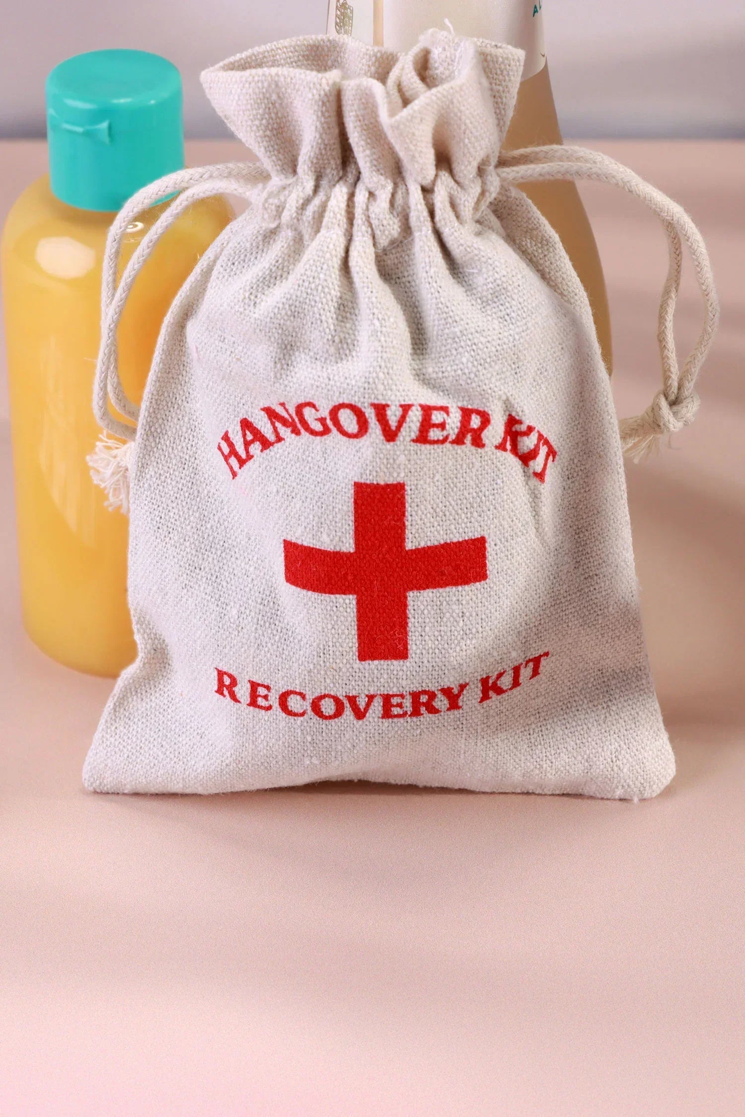 Pair of Hangover Kit Linen Gift Bags with Red Cross Design — close-up view, G Decor