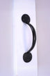 Black metal door handle on white surface, luxury hardware by G Decor
