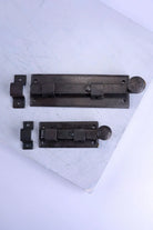 Hand-Forged Hammered Iron Sliding Door Bolt, Beeswax — close-up view, G Decor