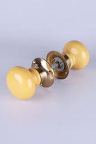 Brassworks Edit Sand Yellow Ceramic Mortice Door Knobs with Brass Base — close-up view, G Decor