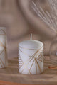 Luxury white candle with gold geometric lines by G Decor, styled on a wooden tray