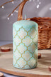 Decorative pillar candle with gold pattern by G Decor, styled on wooden table with wicker basket