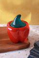 Ceramic red pepper-shaped jar with green lid on wooden board, G Decor kitchen tableware