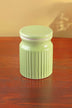 Light green ceramic jar with ribbed texture on wooden table, luxury home décor by G Decor