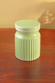 Light green ceramic jar with ribbed texture on wooden table, luxury home décor by G Decor