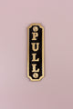 Brass and black metal pull sign hardware by G Decor on a light pink background