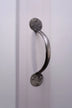 Brushed metal cabinet pull handle on a white paneled door, luxury hardware by G Decor.