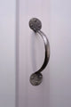 Brushed metal cabinet pull handle on a white paneled door, luxury hardware by G Decor.