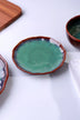 Handcrafted ceramic plate with green glazed center and brown rim on white background, G Decor tableware