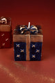 Luxury gift box-shaped candle with gold bow by G Decor, on a rich brown background