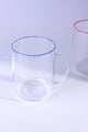 Clear glass mug with blue rim detail on white background, luxury tableware by G Decor
