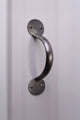 Brushed metal pull handle on white panel door, luxury hardware by G Decor.