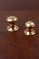Aged brass bun cabinet knobs on stepped roses, 38mm and 32mm