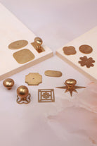 Cabinet knobs and backplates in aged brass, third view