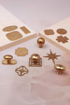 Cabinet knobs and backplates in aged brass