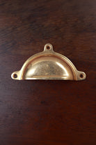Classic aged brass cup pull with three fixing lugs