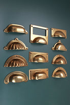 Eleven aged brass cup pulls, angled view