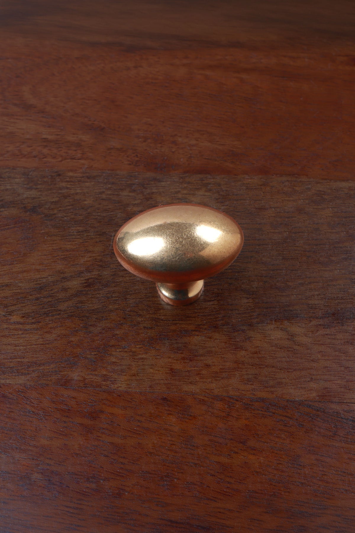 Aged brass oval cabinet knob on a stem