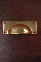 Rounded plate aged brass cup pull, 4 inch