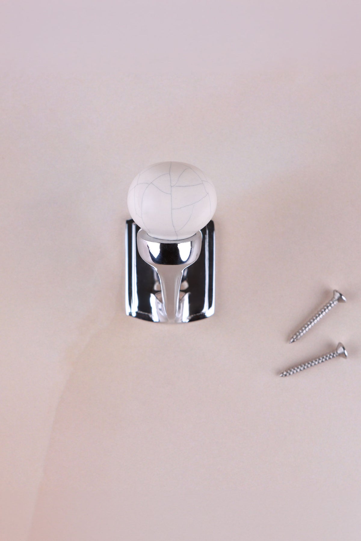Antique ivory crackle glaze ceramic ball hook on a chrome finish hook, with its two screws
