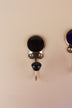 Black ceramic coat hook: black disc in a gold-tone frame with a black ceramic knob