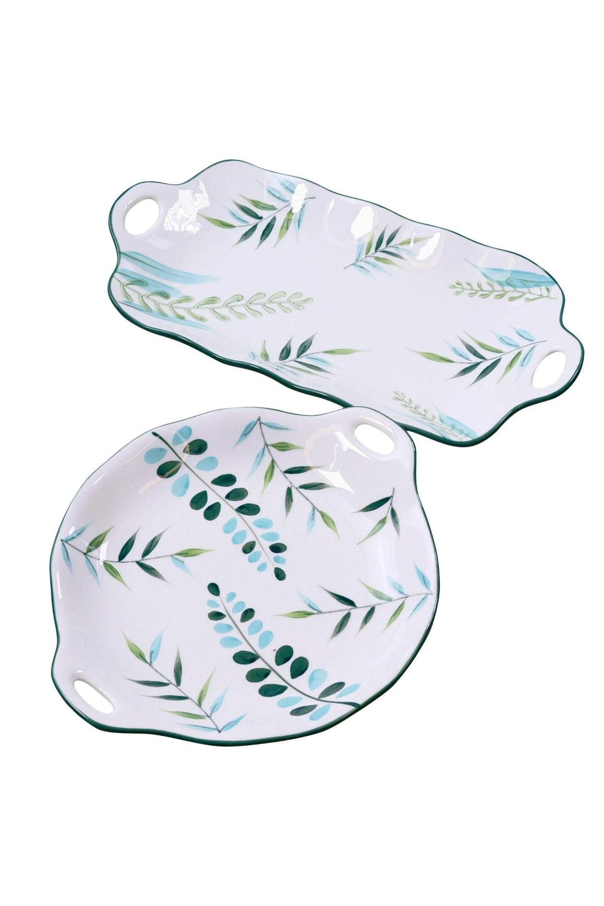 The two leaf serving plates on a white background: the long platter above the round plate