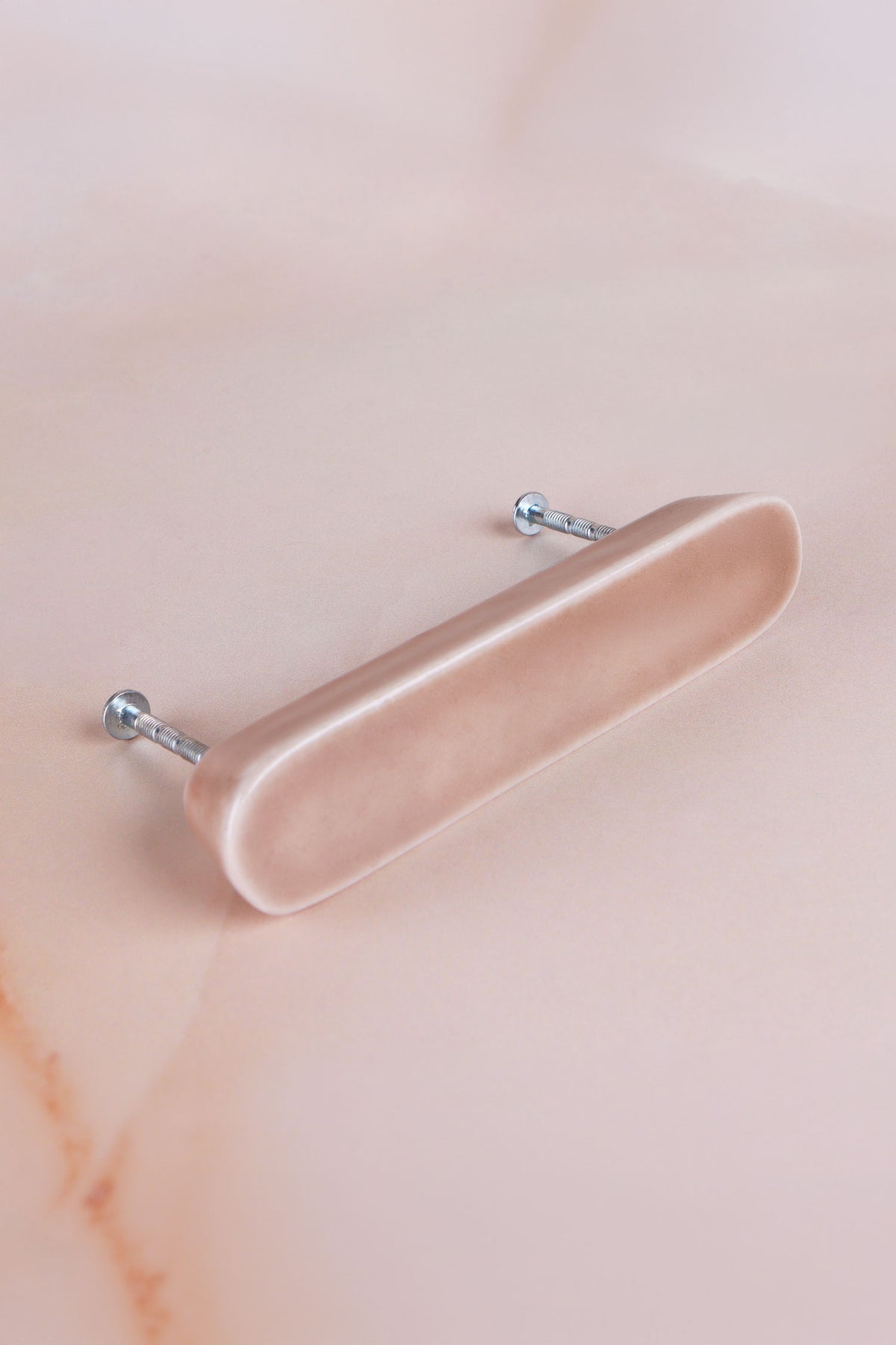 Brown ceramic bar handle, a warm light brown glaze with a fine crackle, with its two fixing bolts